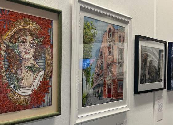 Row of paintings on a white wall