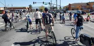 Bicyclists riding along a wide urban stree