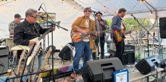 members of a band playing live