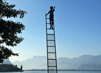 Person climbing a ladder into the sky