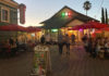 Bar in an old wooden structure with lights twinkling at dusk