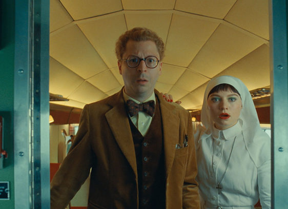 Two people framed in an opening in an aircraft