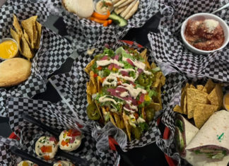 Several baskets of different kinds of food photographed from overhead
