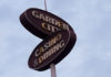 Sign with two ovals that say "Garden City" and "Casino & Dining"