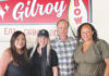 Four people in front of a sign for Gilroy Bowl