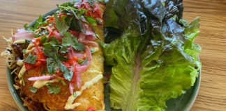 Potato crepe next to large lettuce leaf