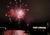 Fireworks seen over a lake