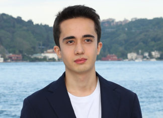 Young man in front of a body of water