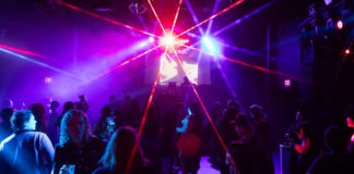 People in a nightclub with dramatic lighting