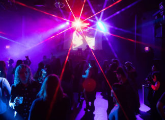 People in a nightclub with dramatic lighting