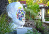 large white bust with colored paint on the face