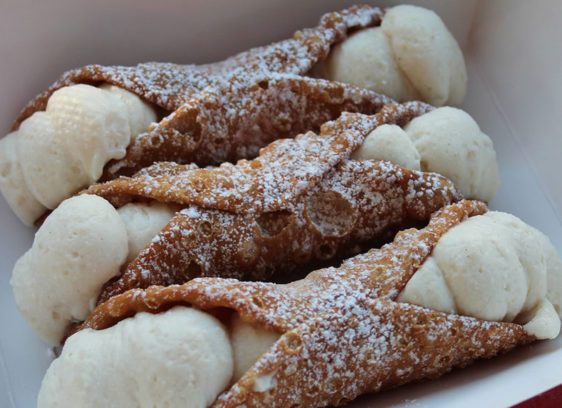 Three cannoli on a plate