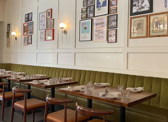 Interior of a restaurant with lots of artwork on the walls
