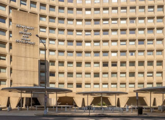 Front of a large, multistory beige building