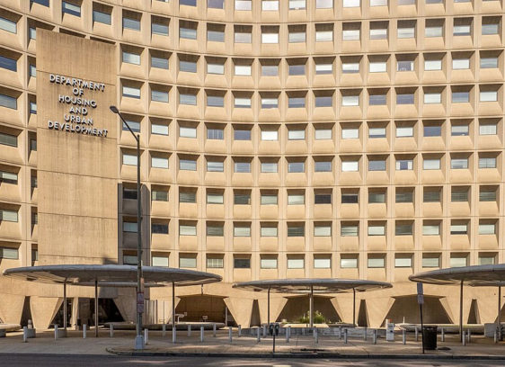 Front of a large, multistory beige building