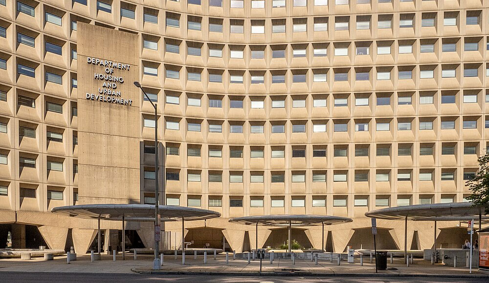 Front of a large, multistory beige building