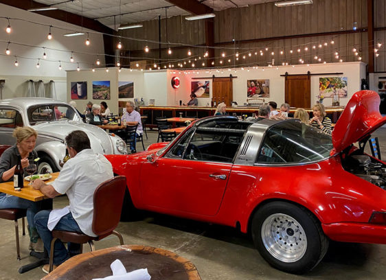 Room with cars and restaurant tables