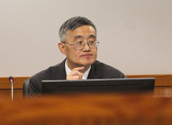 Man sitting behind a desk at a meeting