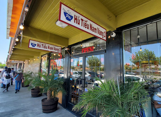 Exterior of stores at a strip mall with signs in Vietnamese