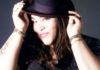 Woman posing with a hat on