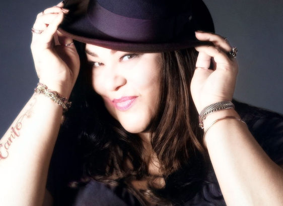 Woman posing with a hat on