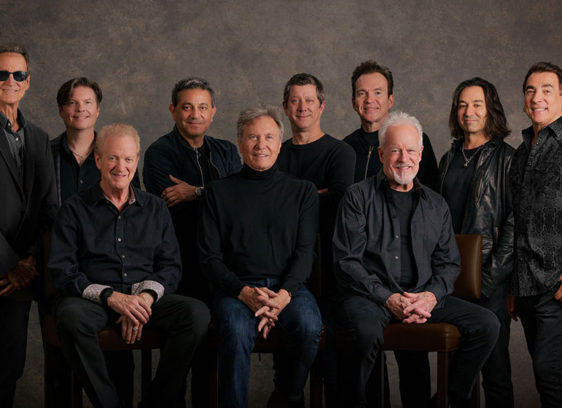 10 musicians posing for a formal band portrait
