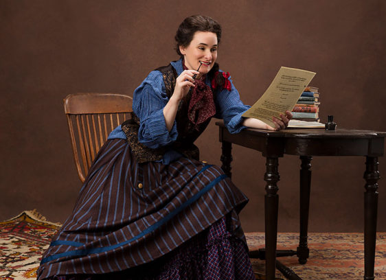 Woman on stage dressed in 19th-century clothing