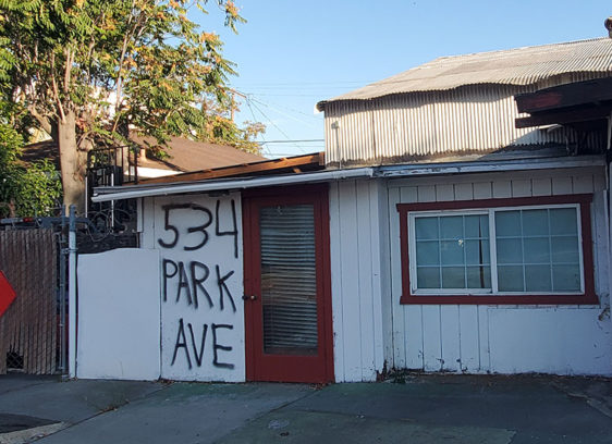 Building that looks empty with its address written on the door.