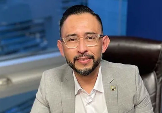 Man in a suit sitting at a desk