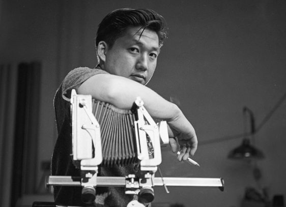 Man leaning on a vintage camera