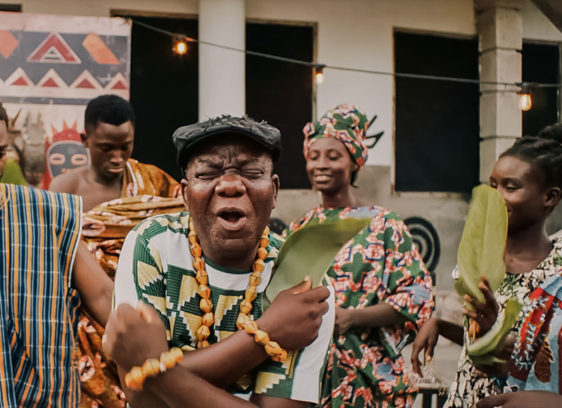 Photo of a man holding an object and making a funny face