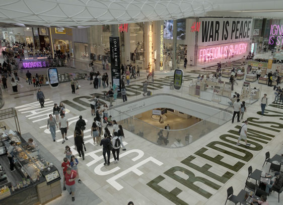 Shopping mall with a bunch of slogans superimposed on various surfaces