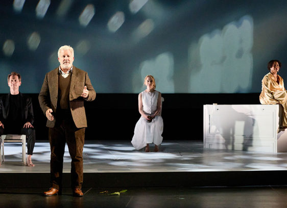 Four people doing a performance on a stage