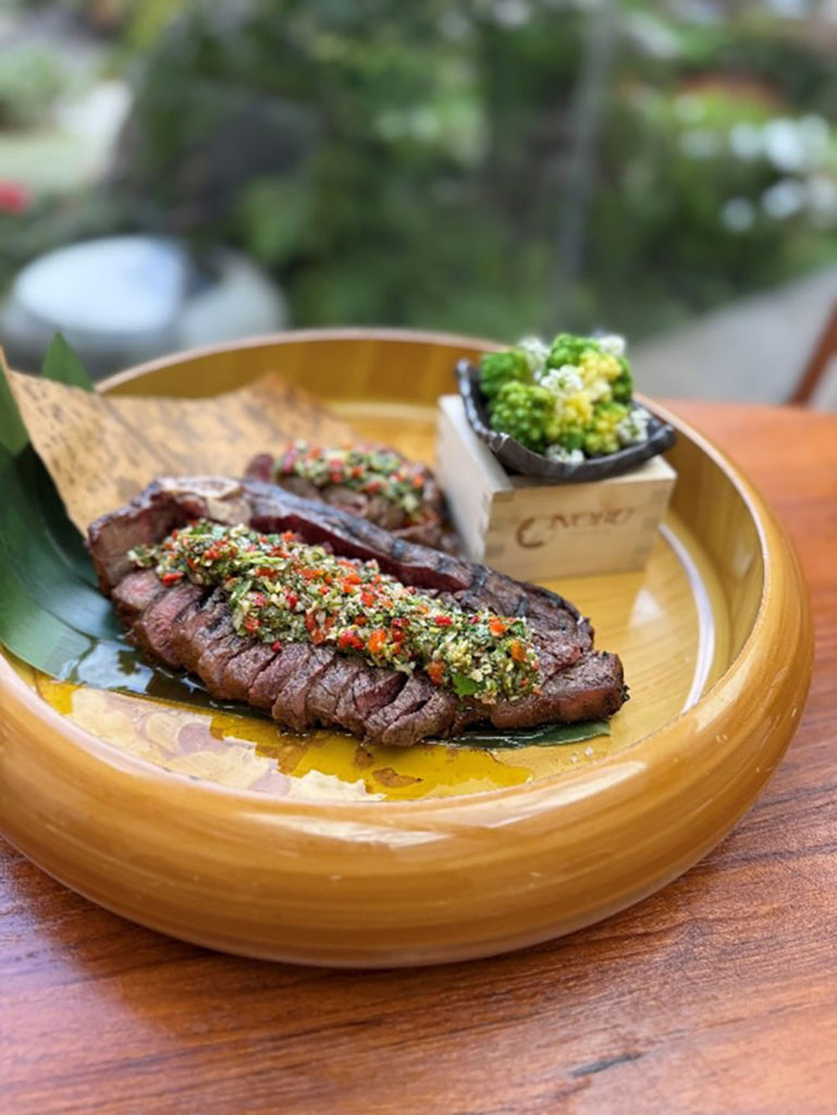 Large platter with a sliced steak ready for serving