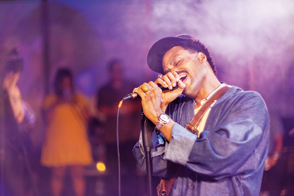 Man singing into a microphone in a club