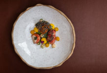 Food in the middle of a very large plate, photographed from above