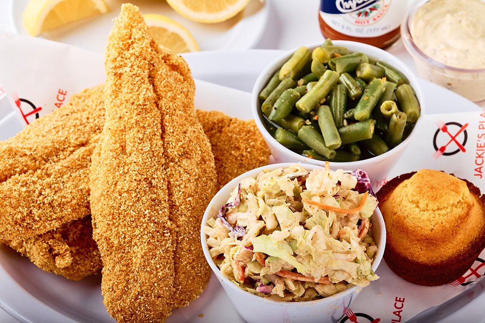 Plate of breaded fish with green beans, cole slaw and cornbread