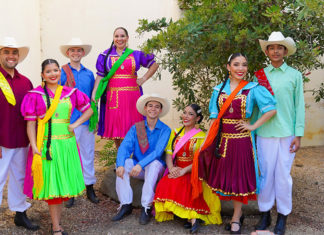 Group of people in brightly colored Mexican folk dance costumes