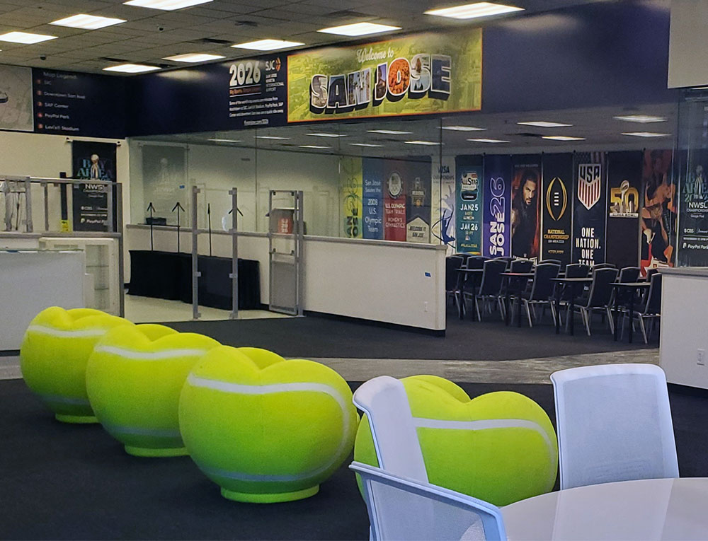 Photo of an empty room with chairs shaped like fluorescent yellow tennis balls