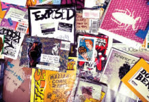 Copies of zines scattered on top of each other, photographed from above