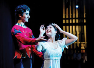 Two ballet dancers in costume on stage