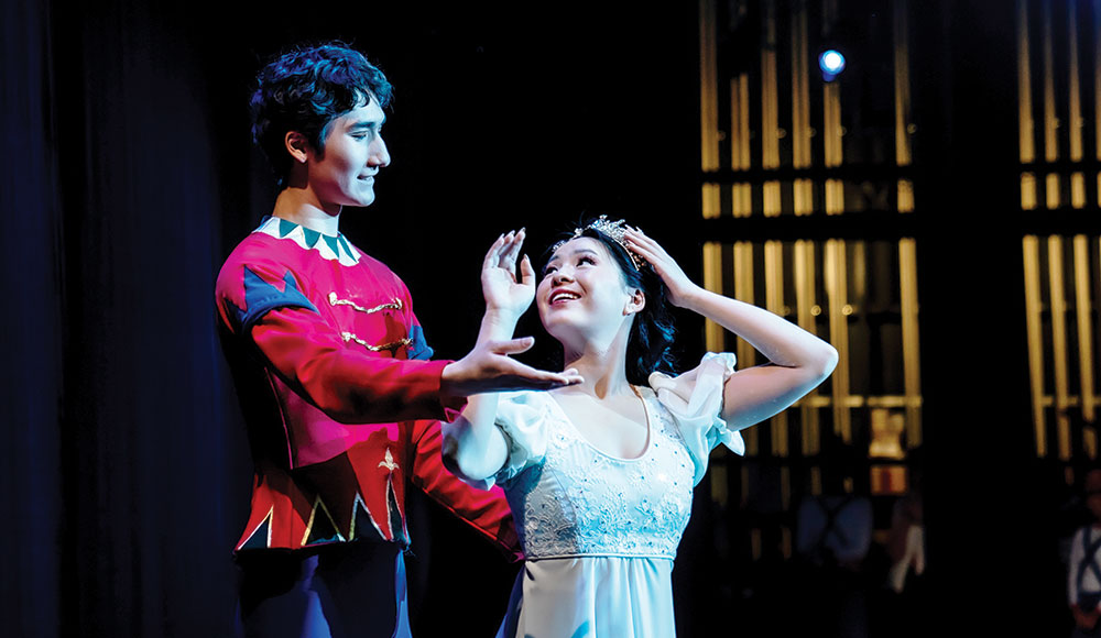 Two ballet dancers in costume on stage