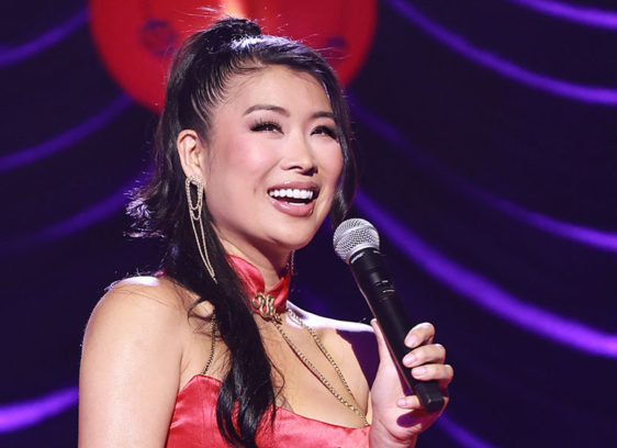 Woman on stage holding a microphone