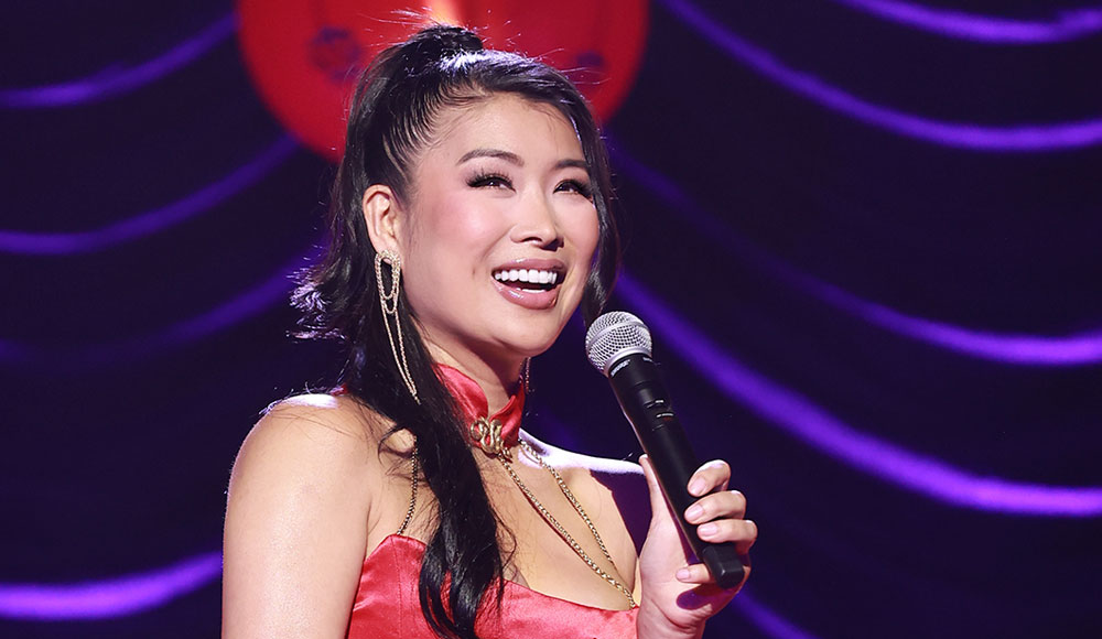 Woman on stage holding a microphone