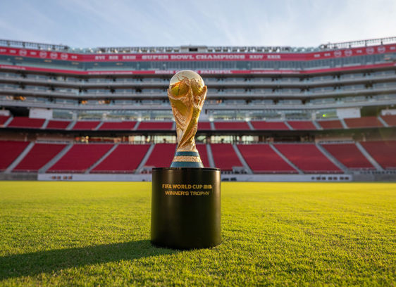 Sports stadium with FIFA World Cup trophy sitting in the middle of the green
