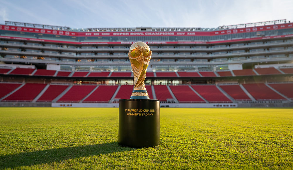 Sports stadium with FIFA World Cup trophy sitting in the middle of the green
