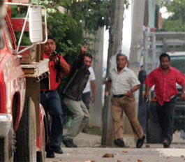 Oaxaca police officers firing at the crowd